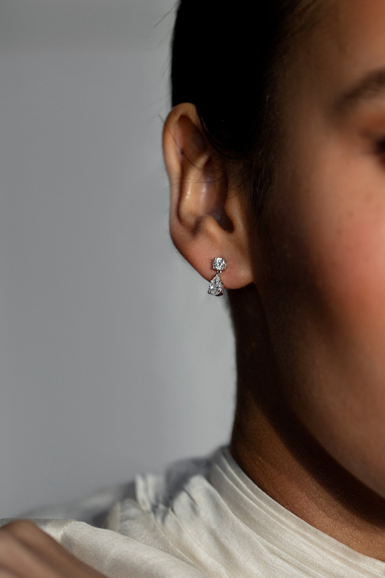 Elegant and timeless diamond stud earrings featuring one pear-cut and one round-cut diamond, crafted from sustainable lab-grown diamonds and 18k solid gold.