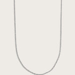 Simple silver chain necklace displayed on a light beige background.