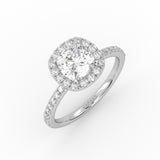 Elegant cushion-cut diamond solitaire engagement ring in white gold with a diamond Pavé band and Halo design.