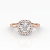 A dazzling cushion-cut diamond nestled on a sparkly halo setting and sophisticated rose gold band.
