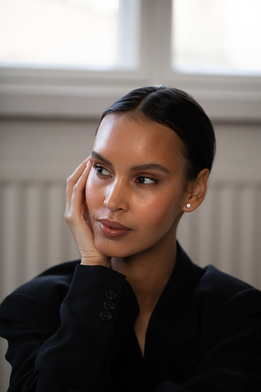 Elegant and stylish woman wearing Round Diamond Studs, made of sustainable lab-grown diamonds and 18k solid gold. 