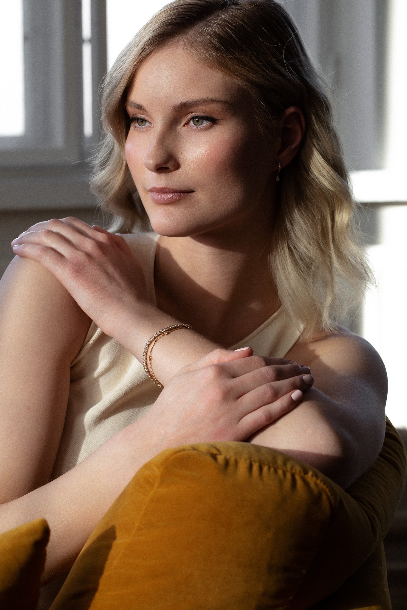 Elegant woman wearing sustainable Diamond Station Bracelet that is made of ethical lab-grown diamonds and recycled solid gold. 
