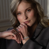 Elegant woman wearing luxurious Diamond Tennis Bracelet that is made of ethical lab-grown diamonds and 18k solid gold. 