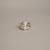 Product focus on the KARAAT Emerald Trilogy in 18k yellow gold, showcasing the clear step-cut lab-grown diamonds.