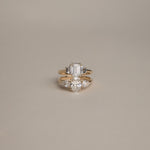 Product focus on the KARAAT Emerald Trilogy in 18k rose gold, showcasing the clear step-cut lab-grown diamonds.