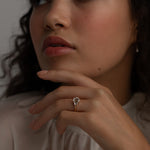 A KARAAT Emerald Trilogy ring in 18k white gold worn by a model, providing contemporary bridal inspiration.