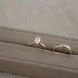 Still life photography of the KARAAT Oval Six Prong Solitaire in 18k yellow gold, showcasing the secure six-prong setting.