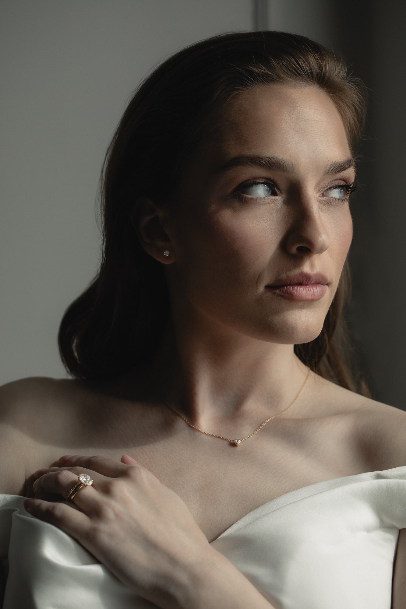 Elegant bridal jewelry by KARAAT featuring a lab-grown diamond engagement ring Oval Solitaire in 18k white gold and matching wedding band, styled for a modern wedding look.