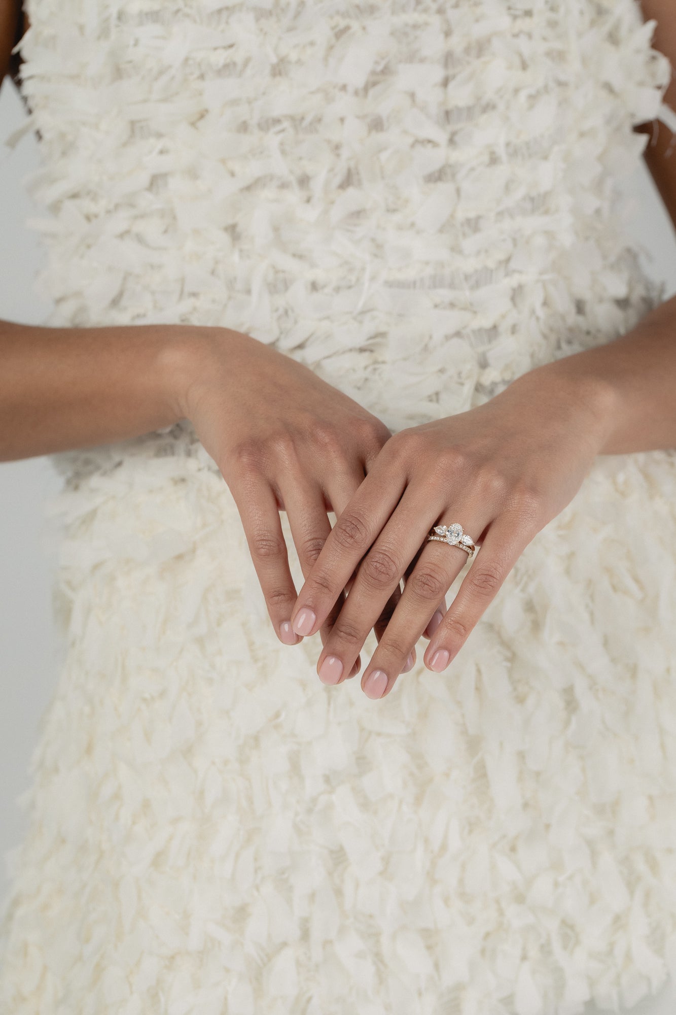 A KARAAT Oval Trilogy diamond ring in 18k white gold, providing elegant bridal inspiration for a modern wedding.
