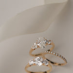 Product photography of the KARAAT Oval Trilogy in 18k yellow gold, detailing the precise three-stone setting.