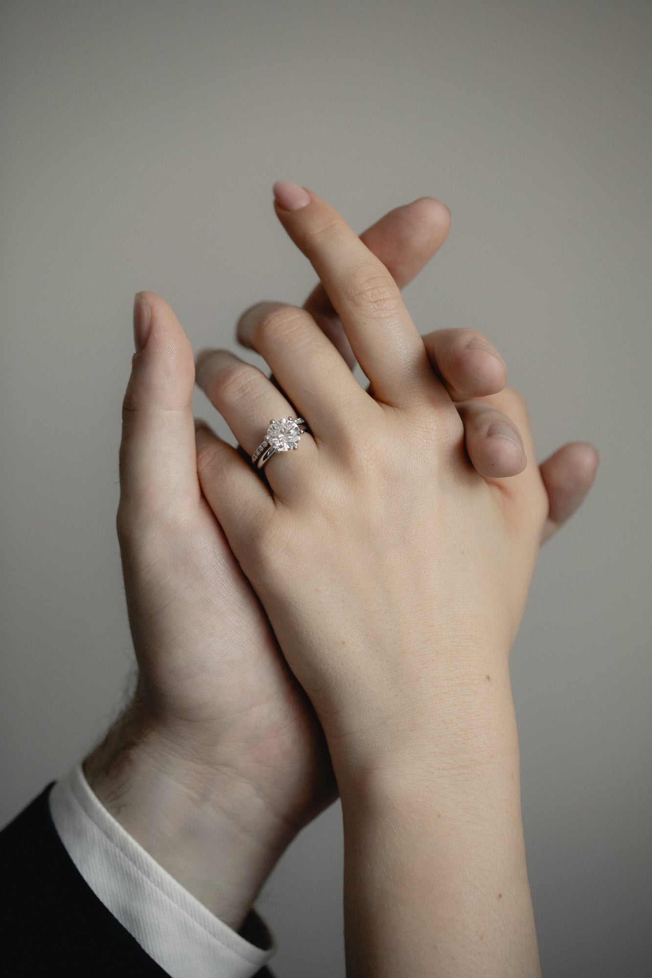 An intimate couple’s moment featuring the KARAAT Round Six Prong Solitaire engagement ring in 18k yellow gold.