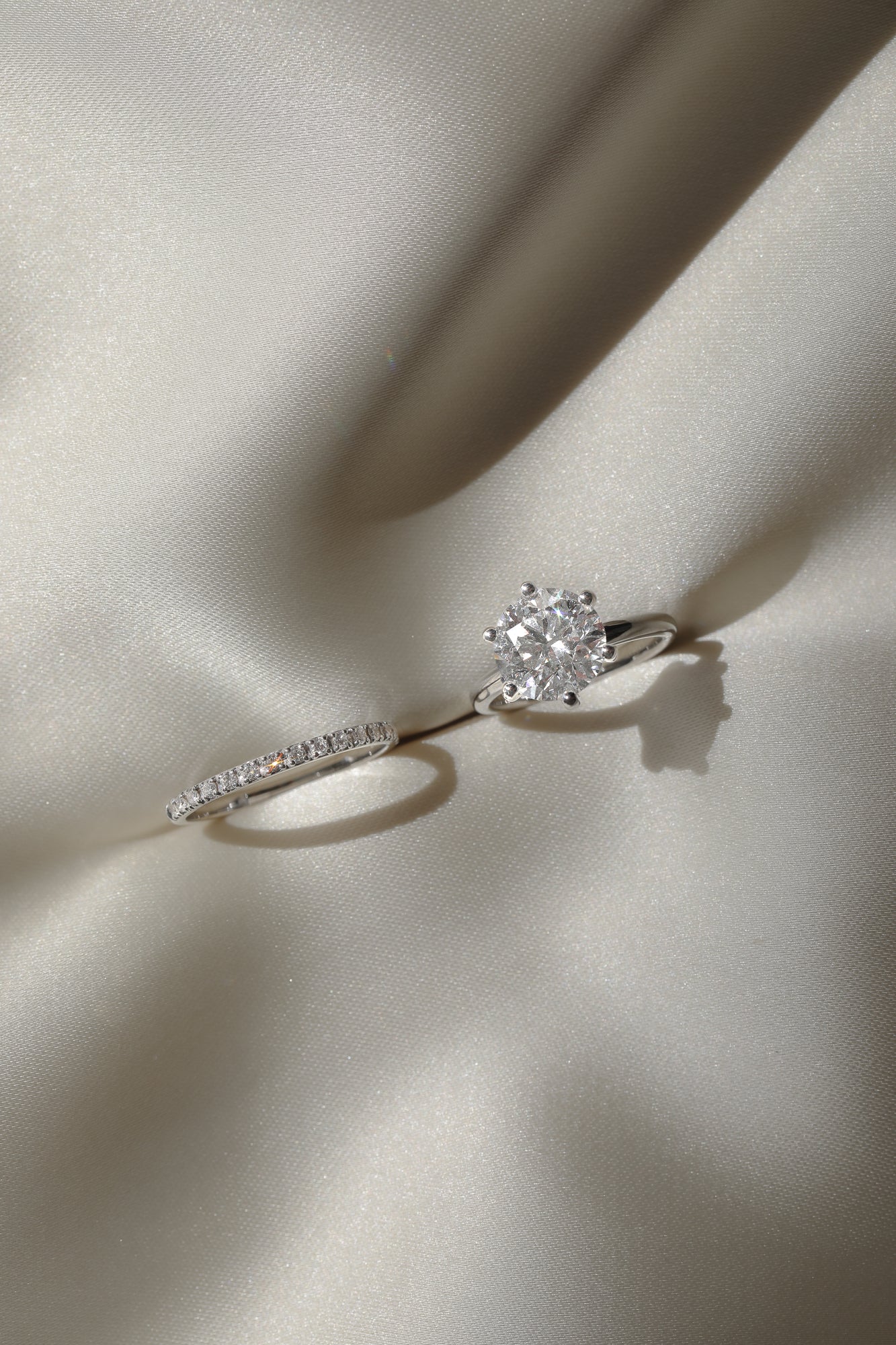 Macro photography of the KARAAT Round Six Prong Solitaire in 18k yellow gold, detailing the diamond facets and prongs.