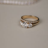 Detailed close-up of the KARAAT Round Trilogy diamond ring in 18k yellow gold, showing the three-stone setting.