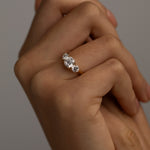 The KARAAT Round Trilogy engagement ring in 18k white gold shown on a model, highlighting its brilliant sparkle.