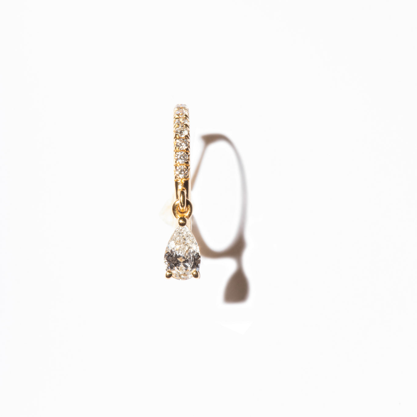 Elegant and timeless diamond earrings with pavé setting and pear-cut diamond, crafted from sustainable lab-grown diamonds and recycled gold. 