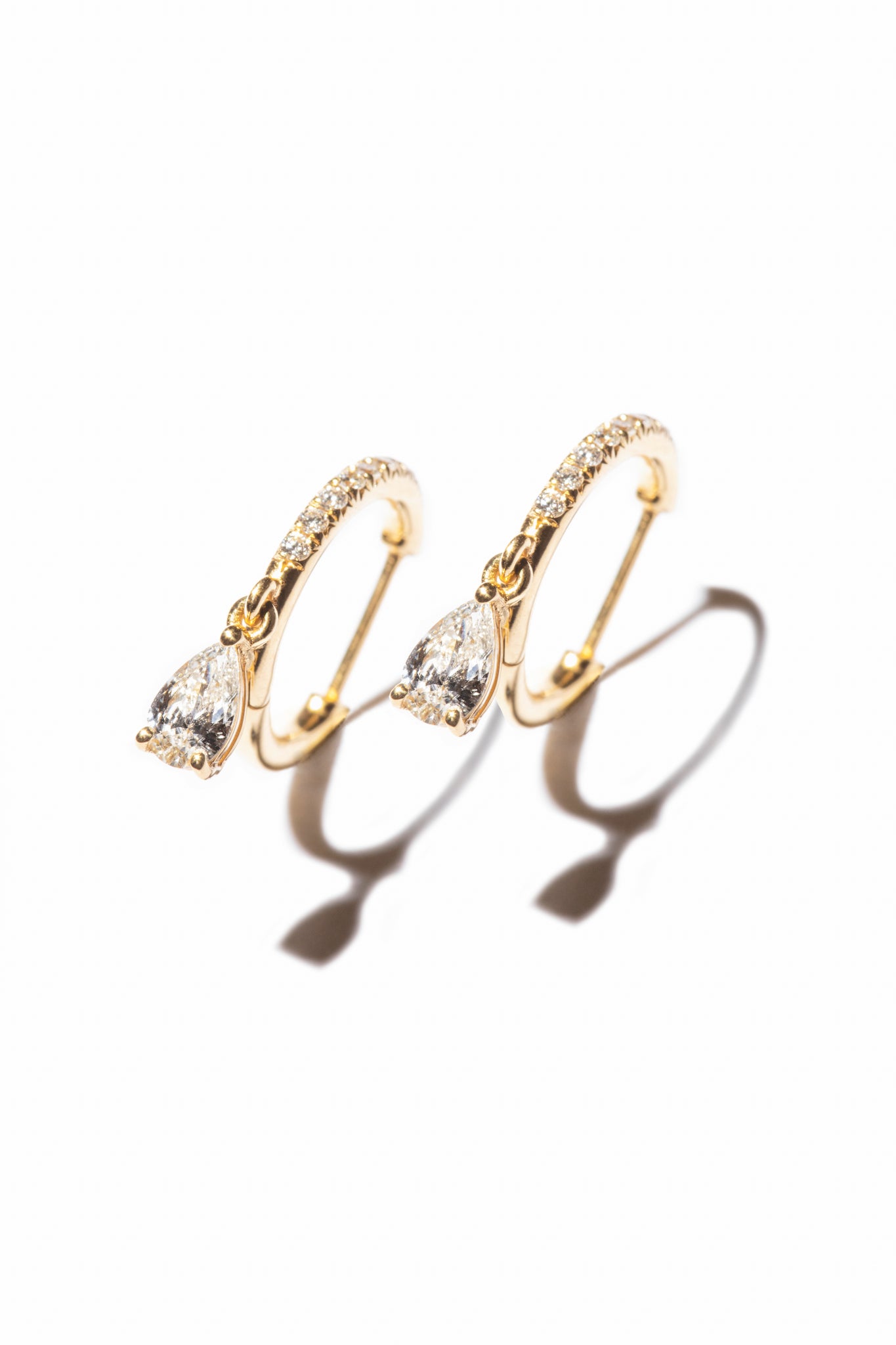 Pear Drop Pavé Huggies, elegant diamond earrings that are made of sustainable lab-grown diamonds and 18k solid gold. 