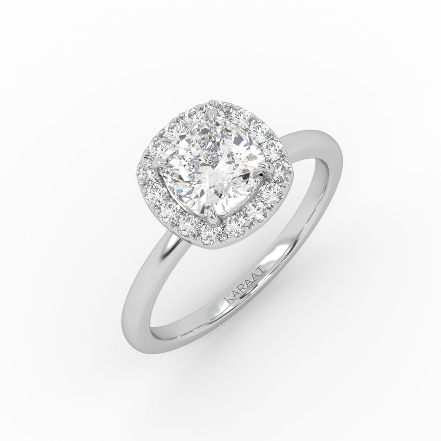 A white gold cushion-shaped solitaire engagement ring showcasing a brilliant 1 carat lab-grown diamond in halo setting. 