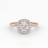 A dazzling cushion-cut diamond nestled on a sparkly halo setting and sophisticated rose gold band. 