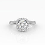 A gleaming cushion-cut diamond engagement ring set in elegant solitaire with halo style.