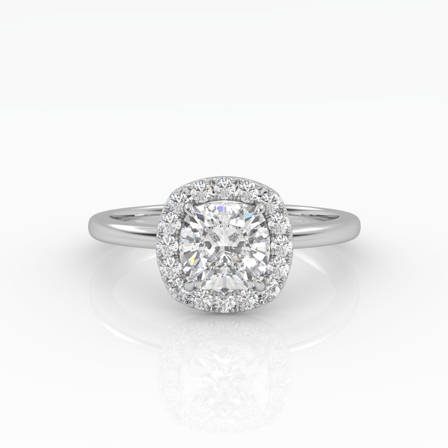 A gleaming cushion-cut diamond engagement ring set in elegant solitaire with halo style.