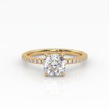 Timeless cushion-cut engagement ring with a lab-grown diamond and a delicate yellow gold pavé band.